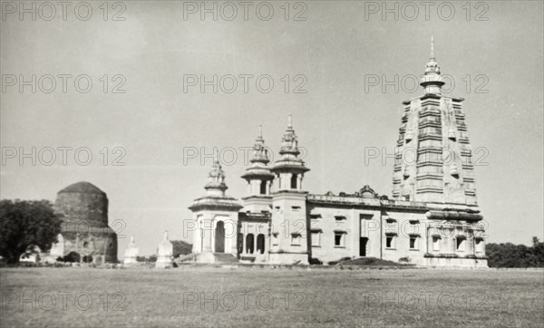 Buddhist Temple at Sarnath. Side view of the Buddhist Temple at Sarnath, showing the sacred Buddhist monument, the Dhamekh Stupa, to the left. Sarnath, United Provinces (Uttar Pradesh), India, circa 1925. Sarnath, Uttar Pradesh, India, Southern Asia, Asia.
