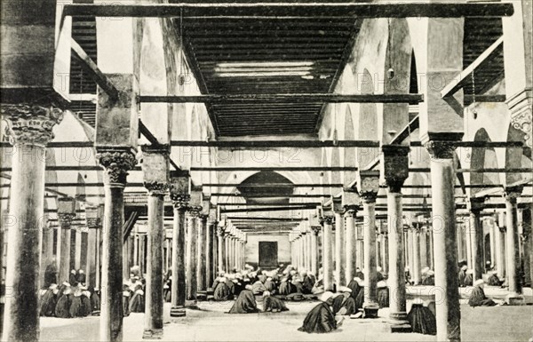 Inside El-Azhar University. Students sit on the floor inside a room lined with pillars at El-Azhar University. Cairo, Egypt, circa 1900. Cairo, Cairo, Egypt, Northern Africa, Africa.