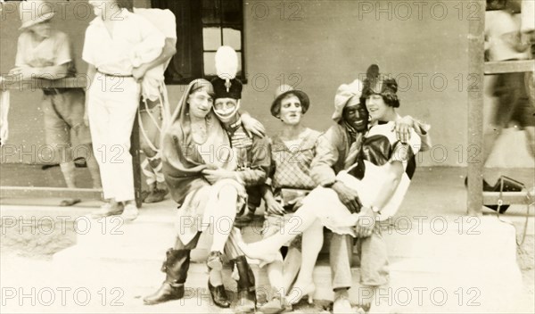 Soldiers in fancy dress. A group of British soldiers pose, wearing a variety of fancy dress costumes for a show they are about to perform. British Mandate of Mesopotamia (Iraq), circa 1925. Iraq, Middle East, Asia.