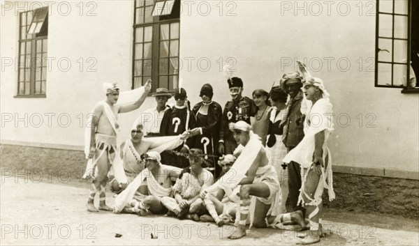 Soldiers in fancy dress. A group of British soldiers pose, wearing a variety of fancy dress costumes for a show they are about to perform. British Mandate of Mesopotamia (Iraq), circa 1925. Iraq, Middle East, Asia.