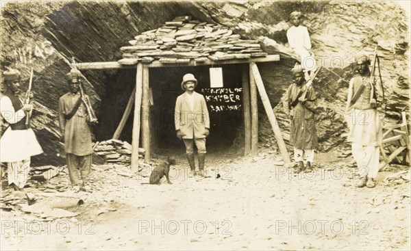 Khyber Railway tunnel. A European supervisor and several Indian armed guards stand at the entrance to a railway tunnel under construction. The tunnel was one of 34 built to accommodate the Khyber Railway that was opened in 1925. India (Pakistan), circa 1915. Pakistan, Southern Asia, Asia.