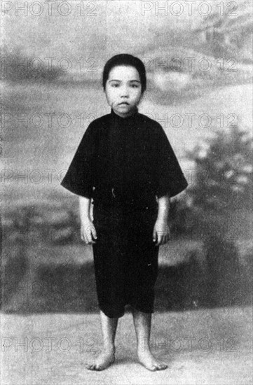The last child sold in Hong Kong. Portrait of a child slave, freed from domestic servitude under the customary Chinese 'mui tsai' system. The girl is identified as 'Ah Moy', aged eight years, and related notes claim she was the last slave to be sold in Hong Kong on 1 July 1929. Hong Kong, (People's Republic of China), circa 1930. Hong Kong, Hong Kong, China, People's Republic of, Eastern Asia, Asia.