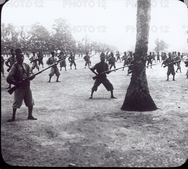 The Congo Public Force. African soldiers in the Force Publique (Congo Public Force) practice a drill holding rifles fitted with bayonets. Congo Free State (Democratic Republic of Congo), circa 1908. Congo, Democratic Republic of, Central Africa, Africa.