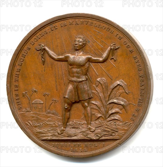 Slavery Abolition Act coin. Close-up of a coin commemorating the United Kingdom's Slavery Aboliton Act, introduced in 1833. The coin depicts a plantation slave holding a broken chain in his outstretched hands and reads: 'This is the Lord's doing: It is marvellous in our eyes. Psalm 118, v.23, Jubilee Augt. 1 1834'. England, August 1834. England (United Kingdom), Western Europe, Europe .