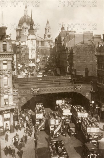 View across Ludgate Circus. View across Ludgate Circus looking towards Ludgate Hill and St Paul's Cathedral. Open-top buses are crammed with commuters and swarms of pedestrians flood the street. London, England, circa 1930. London, London, City of, England (United Kingdom), Western Europe, Europe .