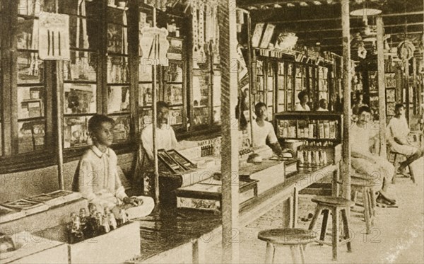Bazaar at Calcutta. Traders wait for customers at a bazaar. Their stalls appear to be located inside, in a room lined with glass-fronted cabinets. Calcutta (Kolkata), India, circa 1900. Kolkata, West Bengal, India, Southern Asia, Asia.