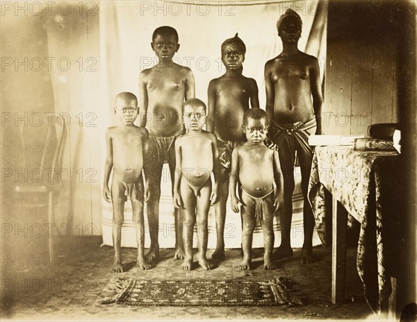Inhabitants of Bioko. Portrait of six semi-naked children from Bioko, posed standing against a makeshift backdrop. Bioko, Equatorial Guinea, circa 1930., Bioko Norte, Equatorial Guinea, Central Africa, Africa.
