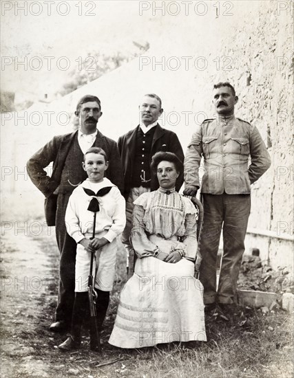 Group portrait in Gibraltar. Group portrait featuring three men, a women and a child. This is one of several photographs taken during a royal visit to Gibraltar by King Edward VII (1841-1910) and Kaiser Wilhelm II (1859-1941). The group featured are probably part of the royal entourage and may even be royal family members. Gibraltar, 1904., Gibraltar, Gibraltar, Mediterranean, Europe .