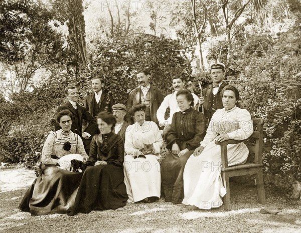 Group portrait in Gibraltar. Group portrait featuring several men and women seated outdoors in a garden. This is one of several photographs taken during a royal visit to Gibraltar by King Edward VII (1841-1910) and Kaiser Wilhelm II (1859-1941). The group featured are probably part of the royal entourage and may even be royal family members. Gibraltar, 1904., Gibraltar, Gibraltar, Mediterranean, Europe .