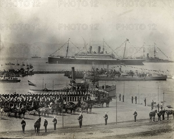 Royal steamship at Gibraltar. British soldiers parade on a dockside in honour of King Edward VII (1841-1910), whose royal steamship sits in harbour, festooned with flags. This is one of several photographs taken during a royal visit to Gibraltar by the British King and his German counterpart, Kaiser Wilhelm II (1859-1941). Gibraltar, 1904., Gibraltar, Gibraltar, Mediterranean, Europe .