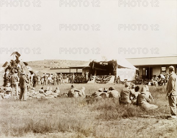 Christmas Day performance at Harrismith. British soldiers and their wives celebrate Christmas Day with a performance held at the 19th Stationary Hospital camp, a convalescent camp established in a valley below the Platberg Mountain during the Second Boer War (1899-1902). Harrismith, Orange River Colony (Free State), South Africa, 25 December 1901. Harrismith, Free State, South Africa, Southern Africa, Africa.