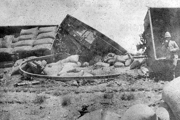 British freight train derailed, South Africa. Several carriages of a railway freight train lie upturned following a derailment. The train's cargo is spilled over the embankment, possibly sacks of supplies or sand bags for trench building. Operating for the British Army during the Second Boer War (1899-1902), the train was probably enroute to a British military base. South Africa, circa 1900. South Africa, Southern Africa, Africa.