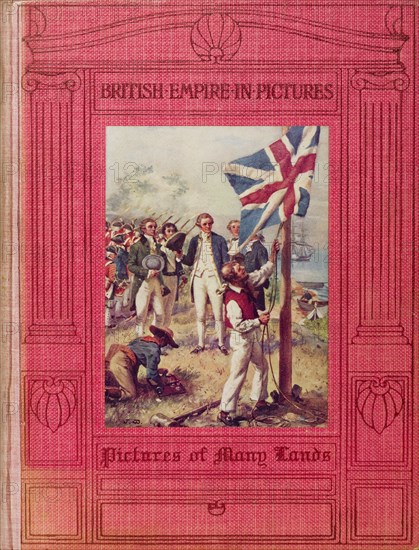 British Empire in Pictures'. The book jacket of 'British Empire in Pictures, Pictures of Many Lands', a publication written by H. Clive Barnard and published in 1910 by Adam and Charles Black, London. The cover illustration features a group of British soldiers, watching as the union jack flag is raised on their arrival in new territory. England, 1910. England (United Kingdom), Western Europe, Europe .