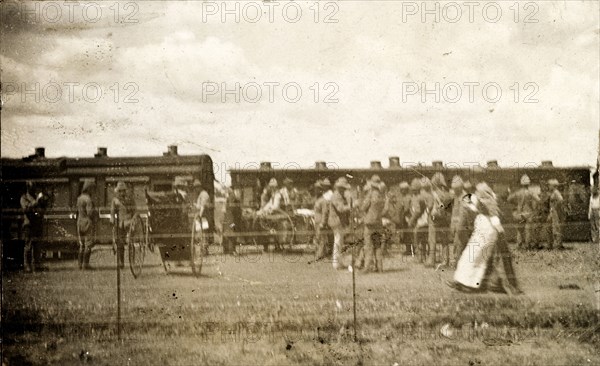 Hospital train at Standerton. A nurse passes a crowd of uniformed troops waiting beside a hospital train at Standerton, a town garrisoned by the British during the Second Boer War (1899-1902). Standerton, Transvaal (Mpumalanga), South Africa, circa 1901. Standerton, Mpumalanga, South Africa, Southern Africa, Africa.