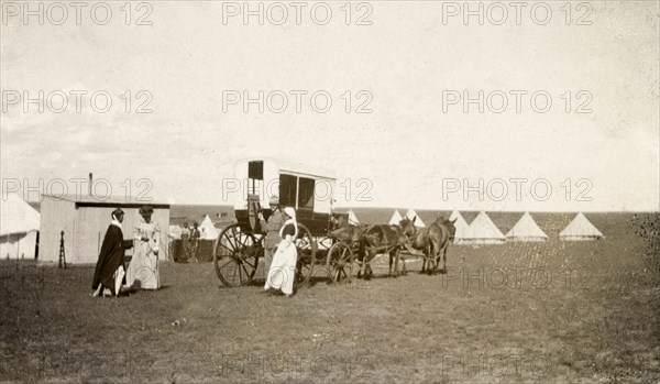 Boer War hospital camp. Two off-duty nurses prepare to board a horse-drawn coach outside a camp designated as a hospital for British troops during the Second Boer War (1899-1902). Standerton, Transvaal (Mpumalanga), South Africa, circa 1901. Standerton, Mpumalanga, South Africa, Southern Africa, Africa.