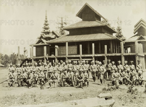 The Royal Artillery at Wuntho. British and Indian soldiers in the Second Mountain Battery of the Royal Artillery pose with two artillery guns in front of Wuntho Palace. The group are pictured shortly after British forces captured Wuntho following a conflict with Burmese rebels. Wuntho, Burma (Myanmar), 1891. Wuntho, Sagaing, Burma (Myanmar), South East Asia, Asia.