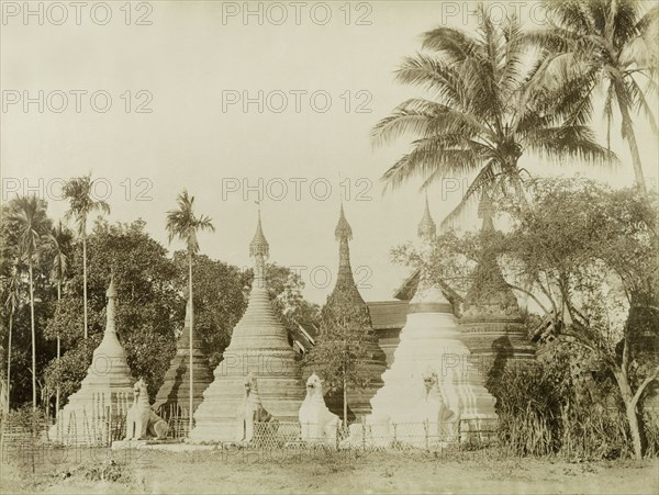 Stone 'zeidis' at Wuntho. Several carved stone 'zeidis' or pagodas are guarded by stone 'chinthes' (mythical Burmese lions) at Wuntho. This scene was captured shortly after British forces took control of Wuntho following a conflict with Burmese rebels. Wuntho, Burma (Myanmar), 1891. Wuntho, Sagaing, Burma (Myanmar), South East Asia, Asia.