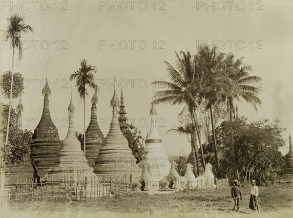 Stone 'zeidis' at Wuntho. Several carved stone 'zeidis' or pagodas are guarded by stone 'chinthes' (mythical Burmese lions) at Wuntho. This scene was captured shortly after British forces took control of Wuntho following a conflict with Burmese rebels. Wuntho, Burma (Myanmar), 1891. Wuntho, Sagaing, Burma (Myanmar), South East Asia, Asia.