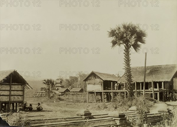 View of Wuntho, Burma (Myanmar). View of Wuntho showing dwellings with thatched roofs supported on stilts, with Wuntho Palace in the distance. This scene was captured shortly after British forces took control of the town following a conflict with Burmese rebels. Wuntho, Burma (Myanmar), 1891. Wuntho, Sagaing, Burma (Myanmar), South East Asia, Asia.