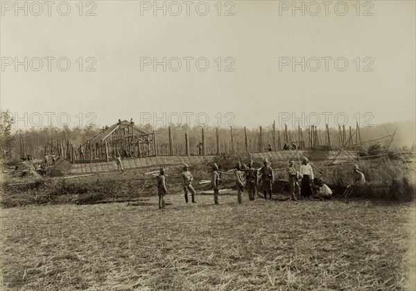 Stockade built by Lieutenant Chapman. British and Indian soldiers pause for the camera during the construction of a stockade overseen by Lieutenant R.E. Chapman. Possibly a mix of British Army and Military Police officers, the men were involved in a campaign to suppress Burmese rebels in Wuntho State (Sagaing Division). Youngma, Burma (Myanmar), 1891. Youngma, Sagaing, Burma (Myanmar), South East Asia, Asia.