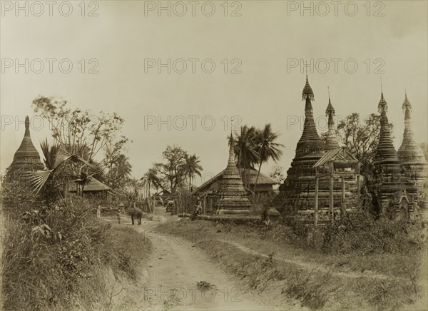 The road into Youngma. The road leading into Youngma, lined with carved stone 'zeidis' or pagodas. This scene was captured during the British campaign to suppress Burmese rebels in Wuntho State (Sagaing Division). Youngma, Burma (Myanmar), circa 1891. Youngma, Sagaing, Burma (Myanmar), South East Asia, Asia.