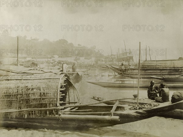 Boats on the Irrawaddy River. Several covered fishing boats are moored along a sandy bank of the Irrawaddy River. Htagaing, Burma (Myanmar), circa 1891. Htagaing, Sagaing, Burma (Myanmar), South East Asia, Asia.