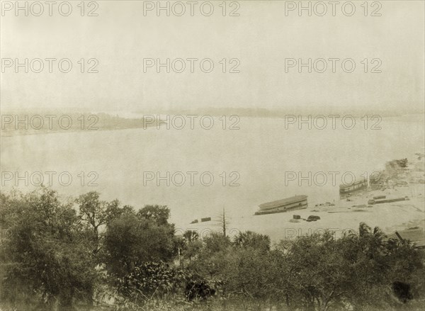 View of the Ayeyarwady River. View across the Ayeyarwady River showing several ferry boats moored alongside the riverbank. Htagaing, Burma (Myanmar), circa 1891. Htagaing, Sagaing, Burma (Myanmar), South East Asia, Asia.
