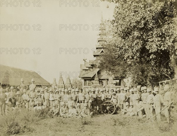 The Royal Artillery in Sagaing. British Army soldiers from a Royal Artillery regiment pose in front of a wooden building with a pagoda-style roof. The company was involved in a campaign to suppress Burmese rebels in Wuntho State (today known as the Sagaing Division). Sagaing, Burma (Myanmar), circa 1891., Sagaing, Burma (Myanmar), South East Asia, Asia.