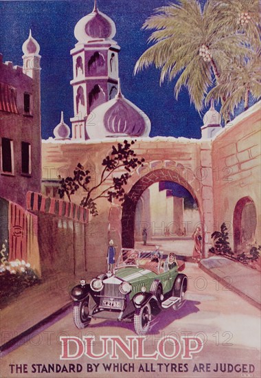 Advertisement for 'Dunlop' tyres. A full-page advertisement for 'Dunlop' tyres, taken from the 1929 edition of 'The Times of India Annual'. The illustration depicts an Indian couple being driven along a city street beside a domed mosque. India, 1929. India, Southern Asia, Asia.
