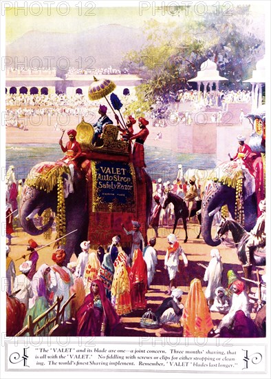 Valet' blades last longer'. A full-page advertisement for 'Valet' razor blades, taken from the 1929 edition of 'The Times of India Annual'. The illustration depicts a procession of decorated elephants making their way through a large crowd gathered along the banks of a river. India, 1929. India, Southern Asia, Asia.