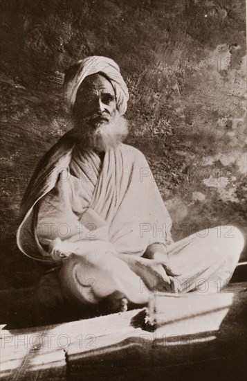 Portrait of Osman Digna. Portrait of Osman Digna (c.1836-1900), sitting cross-legged on a mat, wearing a robe and turban. Digna was a general in the Mahdist army of Sudan from 1883 until his arrest by the British in 1900. Sudan, circa 1887. Sudan, Eastern Africa, Africa.