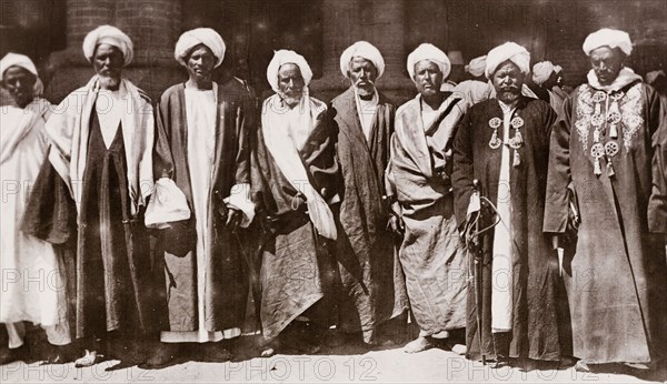 Eight Sheikhs of Kordofan. Portrait of eight Sheikhs from the Kordofan region of Sudan, wearing traditional Arab dress and turbans. Korodfan (probably West Kurdufan State), Sudan, circa 1910., West Kurdufan, Sudan, Eastern Africa, Africa.