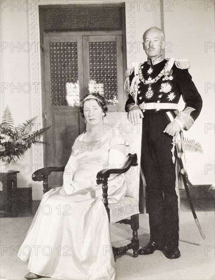 Portrait of Sir Richard and Lady Turnbull. Portrait of Sir Richard Turnbull (1909-1998), the last British colonial Governor of Tanganyika, and his wife, Beatrice, pictured shortly after Tanzanian independence. The couple pose for the camera dressed in formal attire: Sir Richard in full military regalia and Lady Turnball in an evening dress and tiara. Tanganyika (Tanzania), 1962. Tanzania, Eastern Africa, Africa.