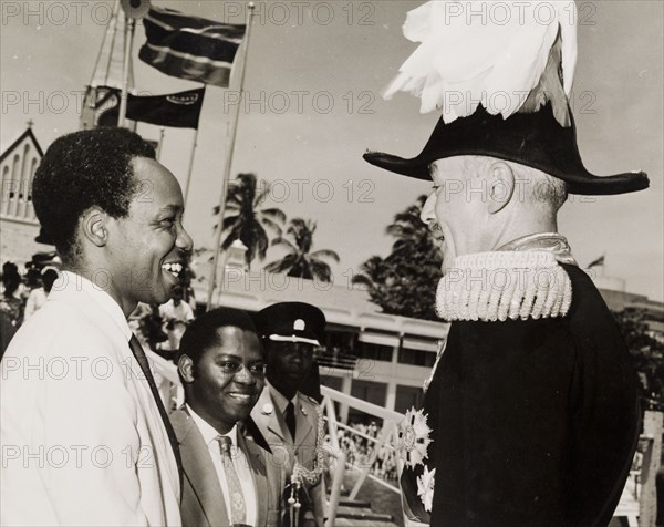 Nyerere and Kawawa say farewell to Sir Richard Turnball. The President of a newly independent Tanzania, Julius Nyerere (1922-1999), and his Prime Minister, Rashid Kawawa (b.1926), bid farewell to Sir Richard Turnbull (1909-1998), the last British colonial Governor of Tanganyika, as he prepares to leave the country. Tanganyika (Tanzania), 8 December 1962. Tanzania, Eastern Africa, Africa.