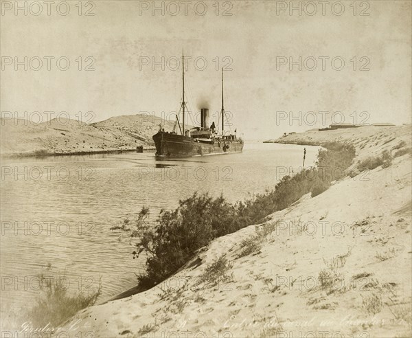 Ship in the Suez Canal, circa 1901. A steamship navigates its way through the Suez Canal. Suez, Egypt, circa 1901., Suez, Egypt, Northern Africa, Africa.