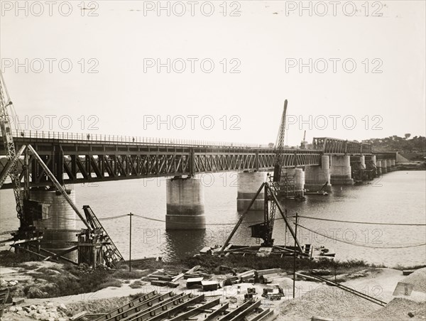 Benue Bridge in the final stages of construction. View of the Benue Bridge in the final stages of its construction. The truss bridge was built across the Benue River by Nigerian Railways. Oweto, Benue State, Nigeria, 24 March 1932. Oweto, Benue, Nigeria, Western Africa, Africa.