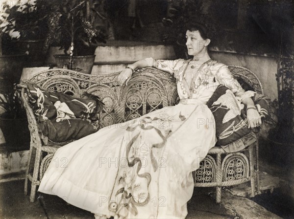 Portrait of Ellen Anne Wood. Portrait of Ellen Anne Wood, the wife of Port Officer G.E. Wood, gracefully reclining on an ornate wicker seat. An original caption comments that her luxurious dress was made by Woodlands of Knightsbridge, London. Port Blair, Andaman and Nicobar Islands, India, 1910. Port Blair, Andaman and Nicobar Islands, India, Southern Asia, Asia.