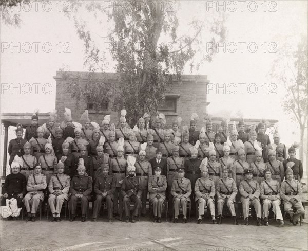 Rawalpindi District Police, 1947. Uniformed officers of the Rawalpindi District Police pose for a group portrait to commemorate the departure of the Superintendent of Police, Ray Mellor. Rawalpindi, Punjab, Pakistan, 5 December 1947. Rawalpindi, Punjab, Pakistan, Southern Asia, Asia.