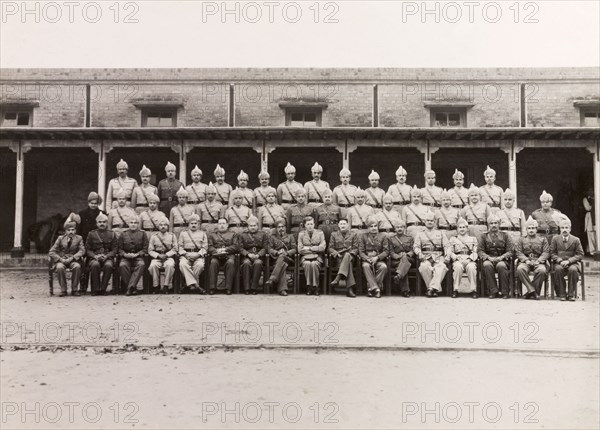 Rawalpindi District Police, 1947. Uniformed officers of the Rawalpindi District Police pose for a group portrait to commemorate the departure of the Superintendent of Police, Ray Mellor. Rawalpindi, Punjab, Pakistan, 1947. Rawalpindi, Punjab, Pakistan, Southern Asia, Asia.