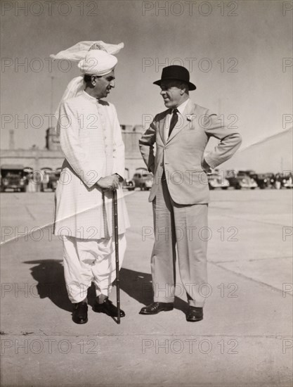 The Prime Minister of Punjab and the Viceroy of India. Malik Khizar Hayat Tiwana (1900-1975), Prime Minister of Punjab, stands and chats 
to Archibald Wavell (1883-1950), Viceroy of India, on the runway at Rawalpindi Airport. Rawalpindi, Punjab, India (Pakistan), 1945. Rawalpindi, Punjab, Pakistan, Southern Asia, Asia.