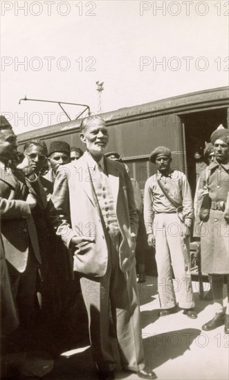 Muhammad Zafrulla Khan arrives at Rawalpindi. Muhammad Zafrulla Khan (1893-1985), Pakistan's first Foreign Minister, stands on a railway platform with a group of Indian dignitaries shortly after arriving at Rawalpindi station. Rawalpindi, Punjab, Pakistan, circa 1947. Rawalpindi, Punjab, Pakistan, Southern Asia, Asia.