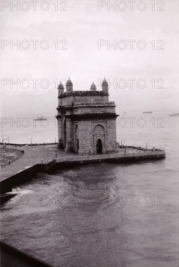 The Gateway of India, Bombay. View of the Gateway of India, situated on the waterfront of Bombay Harbour. Built to commemorate the visit of King George V and Queen Mary in 1911, the Gateway is traditionally the first landmark to be seen by visitors arriving by boat. Bombay (Mumbai), India, circa 1945. Mumbai, Maharashtra, India, Southern Asia, Asia.