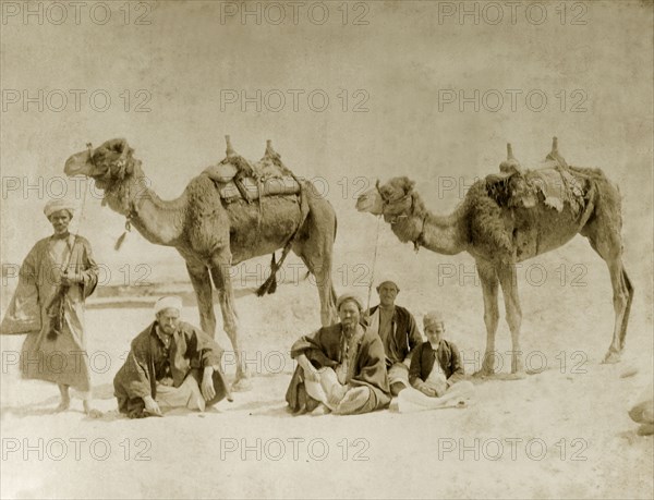 Camel riders near the Suez Canal. A group of Egyptian men and a boy rest with their camels near the Suez Canal. Suez, Egypt, circa 1901., Suez, Egypt, Northern Africa, Africa.
