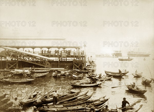 Johnston's Pier, Singapore. Johnston's pier and the waterfront with its inner roadstead. Named after one of Singapore's pioneer businessmen, Alexander Laurie Johnston (d.1855), the pier was originally built in 1854-5. The pier featured here is a newer, enlarged version, constructed by the Public Works Department in 1889-91. Singapore, Straits Settlements (Singapore), circa 1895. Singapore, Central (Singapore), Singapore, South East Asia, Asia.