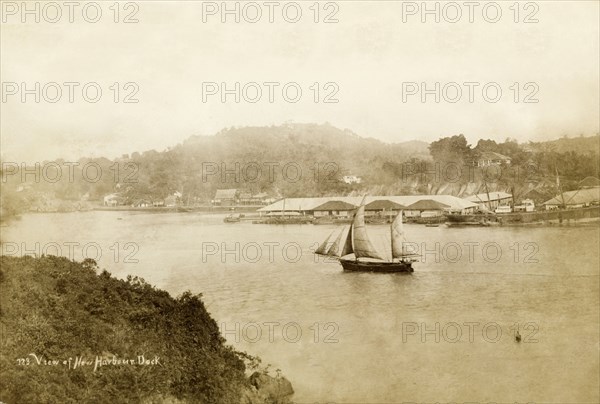 Boat in New Harbour, Singapore. A small boat sails in the waters of New Harbour, situated between Sentosa Island (Pulau Blakang Mati) and Mount Faber. Sentosa Island, Straits Settlements (Singapore), 1901., Sentosa Island, Singapore, South East Asia, Asia.