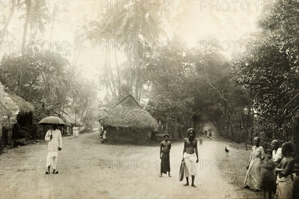 Fork in the road, Colombo. Several people mill about on a fork in the road in Colombo. Colombo, Ceylon (Sri Lanka), circa 1901. Colombo, West (Sri Lanka), Sri Lanka, Southern Asia, Asia.