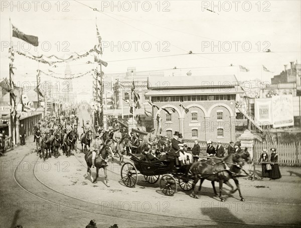 Royal parade through Perth, 1901. A horse-drawn carriage containing the Duke and Duchess of Cornwall and York (later King George V and Queen Mary), parades through the streets of Perth. Perth, Australia, July 1901. Perth, West Australia, Australia, Australia, Oceania.