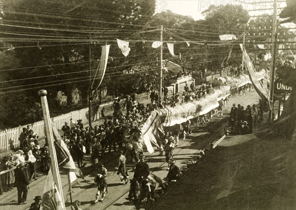 Chinese dragon dance for the royal visit, Perth. A Chinese dragon dance winds its way through Perth's China Town district, part of celebrations to welcome the Duke and Duchess of Cornwall and York (later King George V and Queen Mary) on their visit to the city. Perth, Australia, July 1901. Perth, West Australia, Australia, Australia, Oceania.