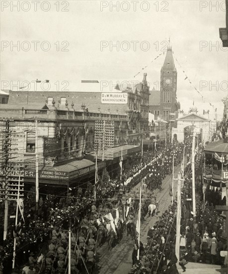 Royal welcome procession, Perth. Crowds line the streets as several military regiments file past Perth's town hall during a welcome procession for the Duke and Duchess of Cornwall and York (later King George V and Queen Mary). Perth, Australia, July 1901. Perth, West Australia, Australia, Australia, Oceania.