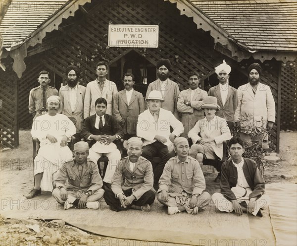 Public Works Department Irrigation Engineers. Burmese irrigation engineers pose in front of the Public Works Department Irrigation headquarters with two European officials, Executive Engineer A.B. Aitken (centre), and to his right, Sub-Divisional Officer, Captain W.L. Roseveare. Mandalay, Burma (Myanmar), May 1924. Mandalay, Mandalay, Burma (Myanmar), South East Asia, Asia.